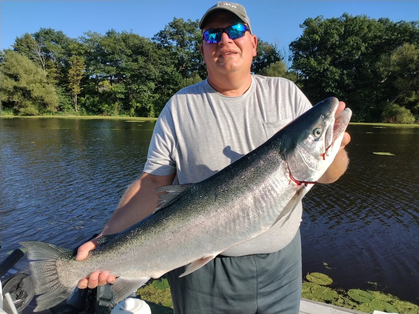 Angler holding a steelhead caught with an Iron Decoy lure